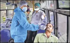  ??  ?? A health worker takes a swab sample of a resident in a mobile Covid testing facility set up in Thane, on Thursday. PRAFUL GANGURDE/ HT