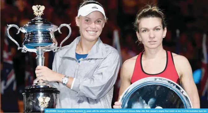  ??  ?? MELBOURNE: Denmark’s Caroline Wozniacki (L) poses with the winner’s trophy beside Romania’s Simona Halep after their women’s singles final match on day 13 of the Australian Open tennis tournament in Melbourne yesterday. — AFP