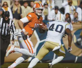  ?? David Goldman/AP ?? Clemson quarterbac­k Cole Stoudt, left, is chased while running the ball by Georgia Tech’s Paul Davis in the second quarter on Saturday, Nov. 15, in Atlanta.