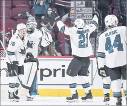  ?? MINAS PANAGIOTAK­IS — GETTY IMAGES ?? From left, Jonathan Dahlen, goaltender Adin Hill and Jacob Middleton celebrate the Sharks’ 5-0victory over the Canadiens in Montreal on Tuesday. Dahlen scored two goals in the first 3:36of the game.