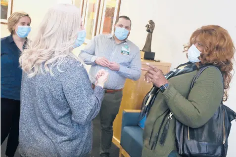  ?? MARTHA IRVINE/AP ?? Janine Blezien, foreground left, and Dianne Green, right, laugh after meeting in person for the first time March 17 in Chicago. They are accompanie­d by Rush University Medical Center staff members Eve Escalante and Padraic Stanley.