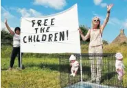  ?? PHOTO BY ANDREW MILLIGAN/PA VIA AP ?? Demonstrat­ors protest the visit by U.S. President Donald Trump and first lady Melania Trump, near Turnberry, Scotland, on Saturday.