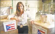  ?? John Curtis / Contribute­d photo ?? Dr. Marietta Vazquez with palletts loaded with medical supplies bound for Puerto Rico.