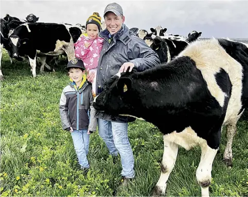  ?? ?? Tim Jelbart with children Alfie and Jemma pictured with some Holstein steers aged around 18 months of age.