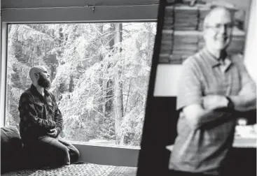  ?? DAVID GOLDMAN/AP ?? Nathan Lambrecht sits near a picture of his father, Doug Lambrecht, among the first COVID-19 victims.