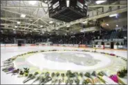  ??  ?? Flowers lay on the ice before a vigil at Elgar Petersen Arena, home of the Humboldt Broncos, to honor the victims of a fatal bus accident April 8.