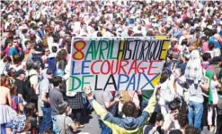  ??  ?? BAYONNE, France: A man holds a placard reading “April 8th the courage of peace” during a rally in support of the “Artisans de la Paix” yesterday following the announceme­nt of disarmamen­t by Basque separatist group ETA. — AFP