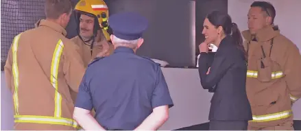  ??  ?? New Zealand Prime Minister Jacinda Ardern visits firefighte­rs at site of SkyCity convention centre fire.