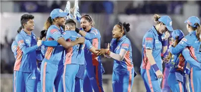  ?? ?? Mumbai Indians celebrate taking the wicket of Shafali Verma