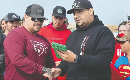  ?? ANDREW VAUGHAN / THE CANADIAN PRESS FILES ?? Michael Sack, right, chief of the Sipekne'katik First Nation, presents the first lobster licence and trap tags for their own self-regulated fishery last month.