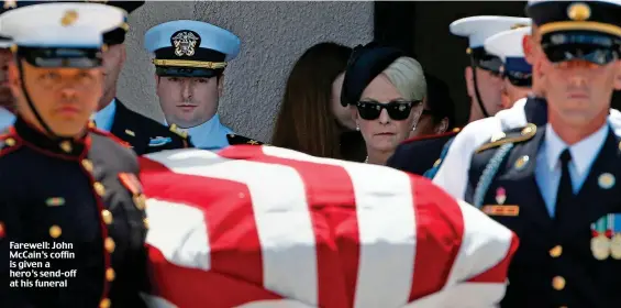  ??  ?? Farewell: John McCain’s coffin is given a hero’s send-off at his funeral