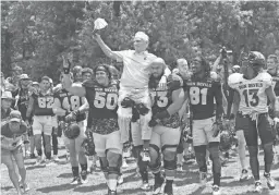  ??  ?? Former head football coach Frank Kush is carried on the shoulders ASU football players at Camp Tontozona outside of Payson in 2015.