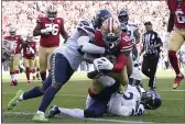  ?? TONY AVELAR – THE ASSOCIATED PRESS ?? 49ers wide receiver Deebo Samuel, middle, scores a touchdown against Seattle on Sunday in Santa Clara.