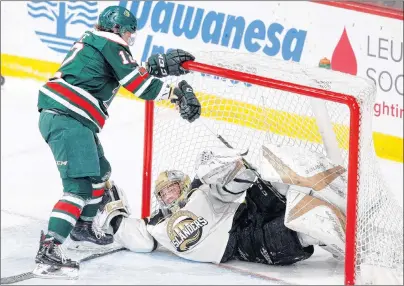  ?? ERIC WYNNE/CHRONICLE HERALD ?? Halifax Mooseheads defenceman Patrick Kyte tries to get loose after getting tangled up with Charlottet­own Islanders goaltender Matthew Welsh during Thursday’s game in Halifax.