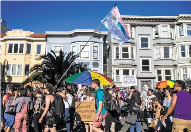  ?? Photos by Jessica Christian / The Chronicle ?? Trans March participan­ts walk along Dolores Street during the kickoff to a weekend of San Francisco Pride. The transgende­r celebratio­n, which drew more than 1,000 people, began in Dolores Park.