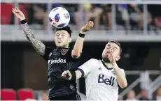  ?? THE ASSOCIATED PRESS ?? D.C. United forward Paul Arriola heads the ball next to Whitecaps midfielder Jordon Mutch during the second half of their match in Washington on Saturday, a 3-1 United victory.