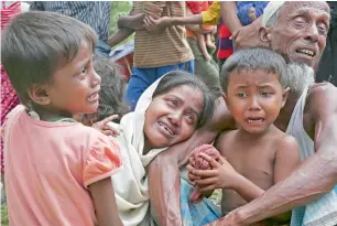  ?? AP ?? A Rohingya Muslimfami­ly in Ghumdhum, Cox’s Bazar, weep as Bangladesh border guards (not pictured) order them to leave their makeshift camp and force them out of the country, on Monday. —