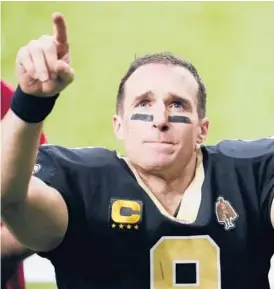  ?? BRYNN ANDERSON/AP ?? Saints quarterbac­k Drew Brees gestures to his family and fans after an NFL divisional round playoff game against the Buccaneers on Jan. 17 in New Orleans.