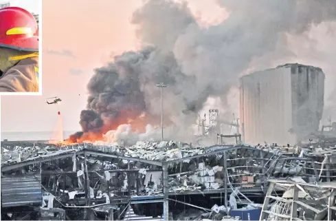  ?? AFP ?? A helicopter puts out a fire at the scene of an explosion at the port of Lebanon’s capital Beirut on Tuesday.