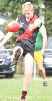  ??  ?? Hunter Paulet kicks Yallourn-Yallourn North forward in the thirds game against Hill End.