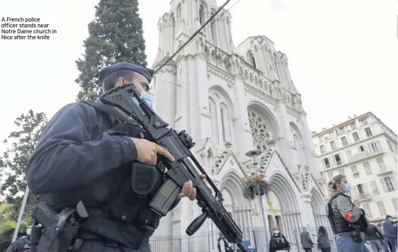  ??  ?? A French police officer stands near Notre Dame church in Nice after the knife
