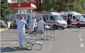  ?? (AFP) ?? Paramedics transfer wheeled gurneys to the Infective Disease Hospital to receive COVID-19 patients, in the Albanian capital of Tirana