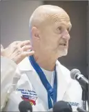  ?? AP PHOTO ?? Hurley Trauma Surgeon Dr. Donald Scholten, M.D. points to his neck at the Merliss Brown Auditorium, in Flint, Mich., to illustrate where Lt. Jeff Neville was stabbed.