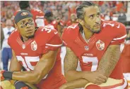  ?? MARCIO JOSE SANCHEZ/ASSOCIATED PRESS FILE PHOTO ?? Then-49ers safety Eric Reid, left, and quarterbac­k Colin Kaepernick kneel during the national anthem in 2016 in Santa Clara, Calif. Kaepernick and Reid have reached settlement­s on their collusion lawsuit against the NFL.