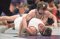  ??  ?? Christian Brothers Evan Anthony and Brentwood Academy Logan Spell wrestle during the region championsh­ips for private school wrestling. Anthony had surgery done in March, a week before COVID-19 forced hospitals to pause elective surgeries.