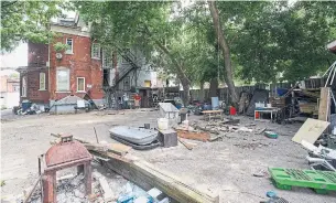  ?? GARY YOKOYAMA THE HAMILTON SPECTATOR ?? The back of 610-12 King St E. is cluttered with debris. Tenants at the multiplex, dubbed “hell’s gates” by one resident, are considerin­g whether to take a new landlord’s buyout offer to vacate.