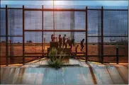  ?? ILANA PANICH-LINSMAN / THE NEW YORK TIMES ?? A group of migrants from Guatemala walk along the Mexican side of the border wall near El Paso, Texas, on June 28.