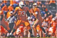  ?? TENNESSEE ATHLETICS PHOTO/ANDREW FERGUSON ?? Tennessee quarterbac­k Jarrett Guarantano looks for a receiver as offensive lineman Trey Smith provides protection during Saturday’s home game against SEC East rival Kentucky. The visiting Wildcats won 34-7 for their largest margin of victory in Neyland Stadium.