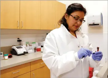  ??  ?? Nikolas Samuels/The Signal (See additional photos at signalscv.com) Medical assistant Patricia Quinteros processes a blood sample at the Newhall Health Center on Wednesday. The community health center opened on Monday and sees all patients, insured and...