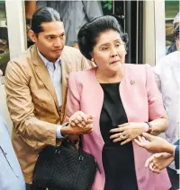  ??  ?? DAY IN COURT – Ilocos Norte 2nd District Representa­tive and former first lady Imelda Marcos is escorted by her grandson Borgy Manotoc as she arrives November 16 at the Sandiganba­yan in Quezon City for a hearing on her appeal to be granted bail pending final conviction. (Kevin Tristan Espiritu)