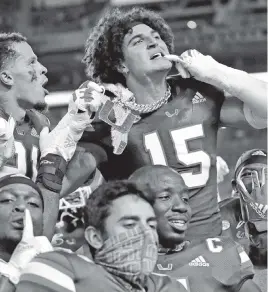  ?? AL DIAZ adiaz@miamiheral­d.com ?? UM defensive end Jaelan Phillips (15) celebrates with the turnover chain after a second-quarter turnover against Florida State at Hard Rock Stadium on Sept. 26, 2020.