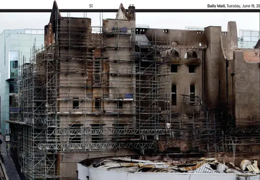  ??  ?? Scene of devastatio­n: Scaffoldin­g had been erected around the GSA yesterday, as work continued on the site