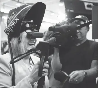  ?? NATHAN DENETTE / THE CANADIAN PRESS ?? Ontario NDP leader Andrea Horwath tests out a virtual-reality welding device as she makes a campaign stop talking with apprentice­s and journeymen at the Ironworker­s’ local 721 office in Toronto on Tuesday.