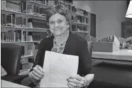  ?? ELIZABETH O’BRIEN/SMITHSONIA­N INSTITUTIO­N ?? Wonder Woman writer Joye Hummel donated her archives to the Smithsonia­n Institutio­n in 2014. In her hands is the psychology take-home exam that had drawn William Moulton Marston’s attention.