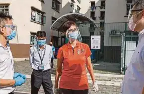  ?? AFP PIC ?? Singapore Manpower Minister Josephine Teo visiting a centre where medical staff are testing migrant workers for Covid-19 in Singapore recently.