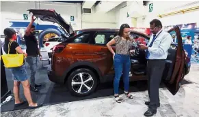  ??  ?? French fare: Visitors having a closer look at the new Peugeot 3008 SUV at Mid Valley Exhibition Centre in Kuala Lumpur.