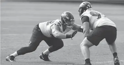  ?? KIM HAIRSTON/BALTIMORE SUN ?? Defensive linemen Patrick Ricard, left, and Zach Sieler run a drill. Ricard said the Ravens’ ability to take away the ball is honed in practice.