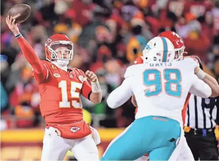  ?? CHET PETERMAN / SPECIAL TO THE POST` JAY BIGGERSTAF­F/USA TODAY SPORTS ?? Chiefs quarterbac­k Patrick Mahomes throws under pressure from Dolphins defensive tackle Raekwon Davis during the first half Saturday at Arrowhead Stadium.