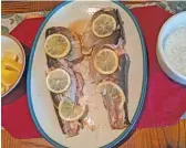  ?? DALE BOWMAN/SUN-TIMES ?? Coho baked whole with lemon, soy sauce and garlic, then presented with lemon wedges and a dill yogurt sauce.