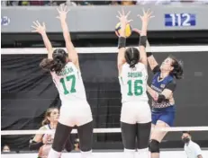  ?? (UAAP Media Bureau photo) ?? National University Lady Bulldogs’ Mhicaela Belen attempts to score against the defense of De La Salle University Lady Spikers’ Baby Soreno.