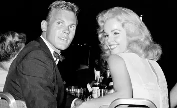  ??  ?? HOLLYWOOD ICON: Actor Tab Hunter with actress Tuesday Weld at a dinner reception in Los Angeles in 1959