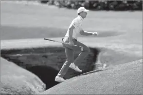  ?? Curtis Compton
/ Atlanta Journal-constituti­on /TNS ?? Jordan Spieth runs across the tributary to Rae's Creek to the 13th green during his practice round for the Masters at Augusta National Golf Club on April 6 in Augusta, Georgia.