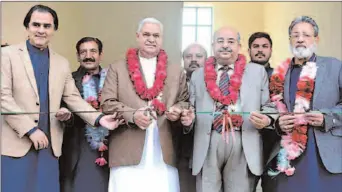  ?? FAISALABAD
-APP ?? State Minister for Textile Hajji Muhammad Akram Ansari is cutting ribbon to inaugurate newly constructe­d classrooms at Government Girls High School Karkhana Bazaar.