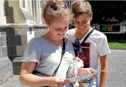  ?? PHOTO: STUFF ?? German tourists Ina Marzahn, left, and Florin Frank have collected plenty of travel brochures during their 4.5-month trip around New Zealand.