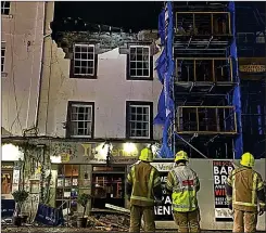  ??  ?? COLLAPSE: Emergency crews at Perth pub after its roof came in