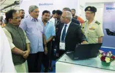  ?? PHOTOGRAPH: ShinMaywa ?? Defence Minister Manohar Parrikar with Cmdre Sujeet Samaddar (Retd), Director and CEO, ShinMaywa Industries India, at the ShinMaywa stall